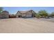 Inviting front exterior featuring a two-car garage, desert landscaping, iron gate, and ample parking space at 907 N Mountain Rd, Mesa, AZ 85207