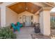 Charming front porch with decorative plants, seating, and a welcoming entrance at 907 N Mountain Rd, Mesa, AZ 85207