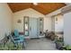 Inviting covered front porch with seating and potted plants, creating a welcoming entrance at 907 N Mountain Rd, Mesa, AZ 85207