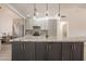 Modern kitchen featuring granite countertops, pendant lighting, and gray cabinets with stainless steel appliances at 907 N Mountain Rd, Mesa, AZ 85207