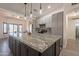 Bright kitchen featuring gray cabinets, a large island, granite countertops, and pendant lighting at 907 N Mountain Rd, Mesa, AZ 85207