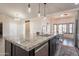 Kitchen island with granite countertop and stainless faucet adjacent to eat-in dining space at 907 N Mountain Rd, Mesa, AZ 85207