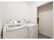 Bright laundry room with modern washer and dryer set and closet shelving at 907 N Mountain Rd, Mesa, AZ 85207