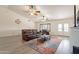 Bright living room featuring vaulted ceilings with dual fans and a leather sofa set at 907 N Mountain Rd, Mesa, AZ 85207