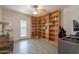 Office space featuring floor-to-ceiling shelves, ceiling fan, and a door to the outside at 907 N Mountain Rd, Mesa, AZ 85207