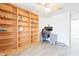 Office space featuring built-in bookshelves, desk, and ceiling fan at 907 N Mountain Rd, Mesa, AZ 85207
