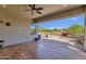 Relaxing covered patio area with an outdoor dining set and ceiling fan at 10350 E Texas Ave, Mesa, AZ 85212