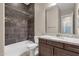 Beautiful bathroom featuring a tub with tiled walls and a modern granite vanity at 10350 E Texas Ave, Mesa, AZ 85212