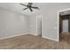 Bedroom with ceiling fan, neutral colored walls, and entrance to another room at 10350 E Texas Ave, Mesa, AZ 85212
