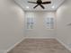 Simple bedroom with plantation shutters, neutral walls, and a ceiling fan at 10350 E Texas Ave, Mesa, AZ 85212