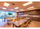 Spacious craft room with tables, chairs, ample storage, and natural light from large windows at 10350 E Texas Ave, Mesa, AZ 85212