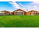Beautiful community clubhouse showcasing stone accents, expansive windows, and well-maintained landscaping at 10350 E Texas Ave, Mesa, AZ 85212