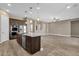 Spacious kitchen with an island and stainless steel appliances seamlessly connected to the living area at 10350 E Texas Ave, Mesa, AZ 85212