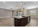 Kitchen island with stainless steel dishwasher and dark cabinets, blending style and functionality at 10350 E Texas Ave, Mesa, AZ 85212