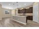 Modern kitchen featuring a granite island, stainless steel appliances, and stylish pendant lighting at 10350 E Texas Ave, Mesa, AZ 85212