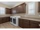 Laundry room boasts ample cabinet space and modern washer and dryer units at 10350 E Texas Ave, Mesa, AZ 85212
