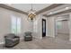 Bright living room featuring decorative light fixtures, neutral walls, and hardwood floors at 10350 E Texas Ave, Mesa, AZ 85212