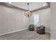Bright living room featuring decorative light fixtures, neutral walls, and hardwood floors at 10350 E Texas Ave, Mesa, AZ 85212