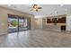 Spacious living area with tile floors, large sliding doors to the patio, and an open kitchen at 10350 E Texas Ave, Mesa, AZ 85212