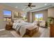 Inviting main bedroom boasts a tray ceiling and natural light from the many windows at 10350 E Texas Ave, Mesa, AZ 85212