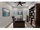 Well-appointed home office with large desk, built-in shelves, and modern entertainment at 10350 E Texas Ave, Mesa, AZ 85212