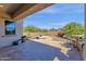 Covered patio with outdoor kitchen island, desert landscaping, and fire pit feature at 10350 E Texas Ave, Mesa, AZ 85212