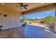 Covered patio overlooking the desert landscaped backyard with BBQ and seating at 10350 E Texas Ave, Mesa, AZ 85212