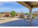 Covered patio with BBQ and comfortable seating overlooking the desert landscaping at 10350 E Texas Ave, Mesa, AZ 85212