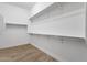 Walk-in closet featuring shelves and chrome bars for maximum storage at 10350 E Texas Ave, Mesa, AZ 85212