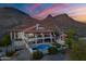 Stunning sunset aerial view of an estate with a pool nestled against picturesque mountains at 1234 E Claire Dr, Phoenix, AZ 85022