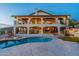 Expansive backyard with a pool, covered patio, spiral staircase, and multi-level landscaping at 1234 E Claire Dr, Phoenix, AZ 85022