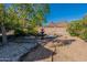 Landscaped backyard with a fountain, brick pathway, and desert views, creating a serene and inviting outdoor space at 1234 E Claire Dr, Phoenix, AZ 85022
