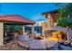 Expansive backyard featuring an outdoor kitchen, covered patio, fountain, and lush landscaping for luxurious outdoor living at 1234 E Claire Dr, Phoenix, AZ 85022