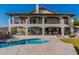 Gorgeous backyard with a sparkling pool, artificial turf, and an elegant home with multiple balconies at 1234 E Claire Dr, Phoenix, AZ 85022