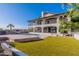 Expansive backyard featuring a pool, lush green lawn, and a multi-level patio perfect for outdoor entertaining at 1234 E Claire Dr, Phoenix, AZ 85022
