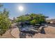 Backyard featuring a fountain, stone picnic table, and desert landscaping at 1234 E Claire Dr, Phoenix, AZ 85022