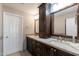 Bathroom featuring granite countertop, dark wood cabinetry, and double sinks at 1234 E Claire Dr, Phoenix, AZ 85022