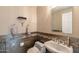 Cozy half bathroom featuring stylish tiled walls, toilet, and sink with mirror at 1234 E Claire Dr, Phoenix, AZ 85022