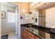 Bathroom boasts wood cabinets, dark countertop, and shower with glass door at 1234 E Claire Dr, Phoenix, AZ 85022