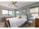 Comfortable bedroom features large windows, ceiling fan and light blue walls at 1234 E Claire Dr, Phoenix, AZ 85022
