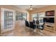 Modern dining area with a glass table, contemporary chairs, and large windows overlooking the backyard at 1234 E Claire Dr, Phoenix, AZ 85022