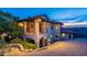 Beautiful home exterior with a covered patio, tiled roof, desert landscaping, and tasteful lighting, set against a scenic backdrop at 1234 E Claire Dr, Phoenix, AZ 85022