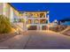 Three-story home with desert landscaping and a three car garage at 1234 E Claire Dr, Phoenix, AZ 85022