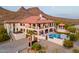 Beautiful two-story home featuring a terracotta roof, balconies on each level, and a backyard pool and gazebo at 1234 E Claire Dr, Phoenix, AZ 85022
