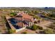 Lovely two-story home with a terracotta roof, spacious lot, desert landscaping, and mountain views in the background at 1234 E Claire Dr, Phoenix, AZ 85022