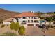 Beautiful two-story home showcasing a large driveway, balconies, terracotta tile roof, and lush landscaping at 1234 E Claire Dr, Phoenix, AZ 85022