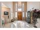 Grand foyer featuring a high ceiling, tile floors, statement chandelier, and a decorative front door at 1234 E Claire Dr, Phoenix, AZ 85022