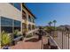 Exterior view of the home with a terraced patio area, stone benches and landscaping at 1234 E Claire Dr, Phoenix, AZ 85022