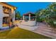 Charming outdoor space featuring a gazebo, multi-tiered landscaping, and integrated lighting at 1234 E Claire Dr, Phoenix, AZ 85022