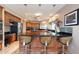 Bright kitchen features an island with seating, black countertops and stainless appliances at 1234 E Claire Dr, Phoenix, AZ 85022